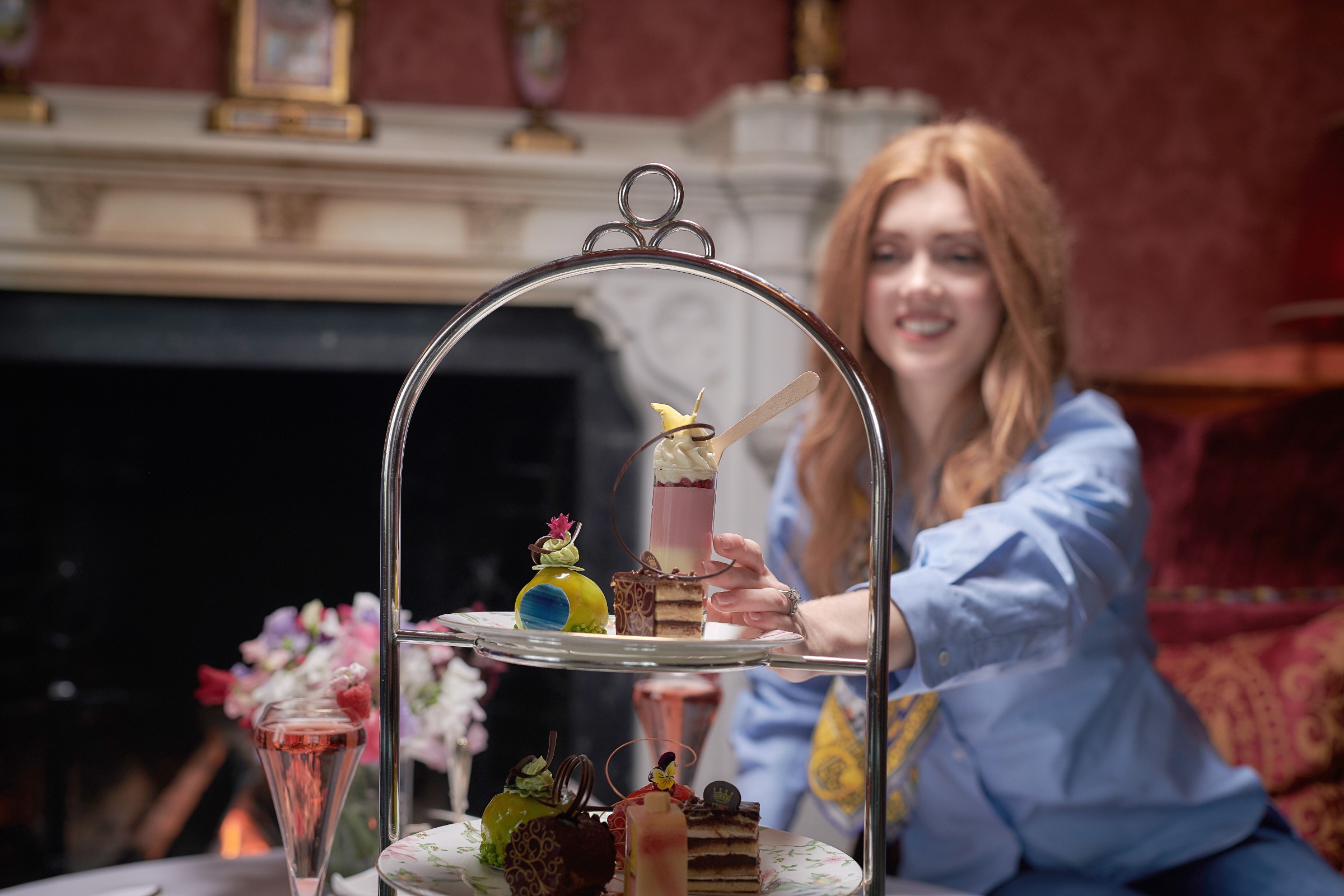 Lady reaching for a dessert at Dromoland Castle afternoon tea
