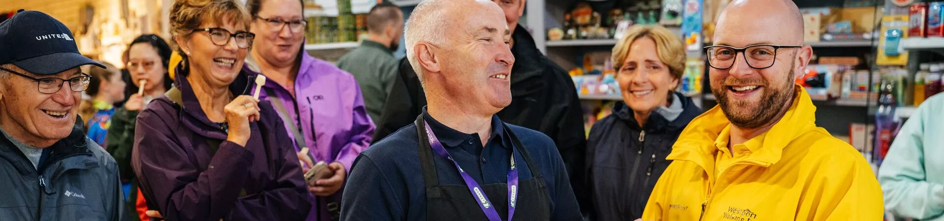people laughing at a food store