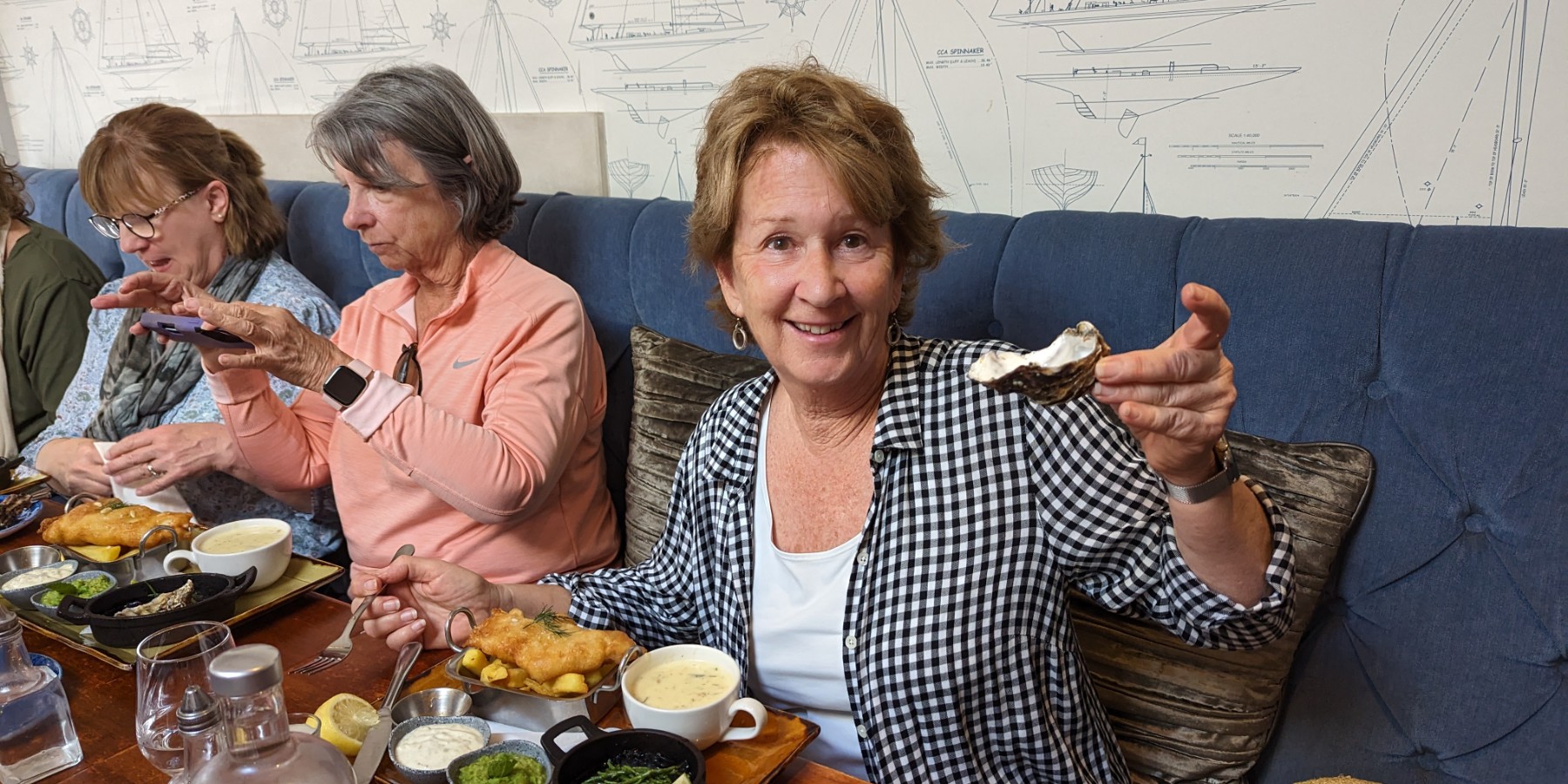 A group of women sitting at a table eating lunch with oysters on Kinsale Food Tour