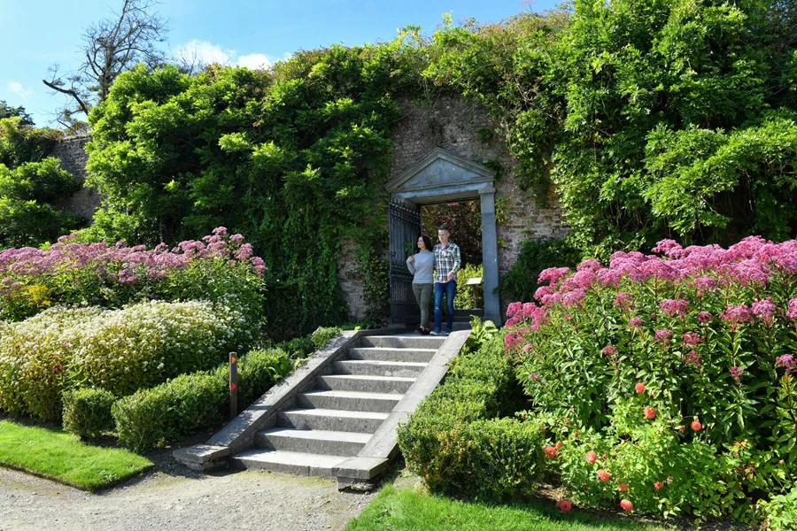Couple standing in an English garden enjoying the spring flowers