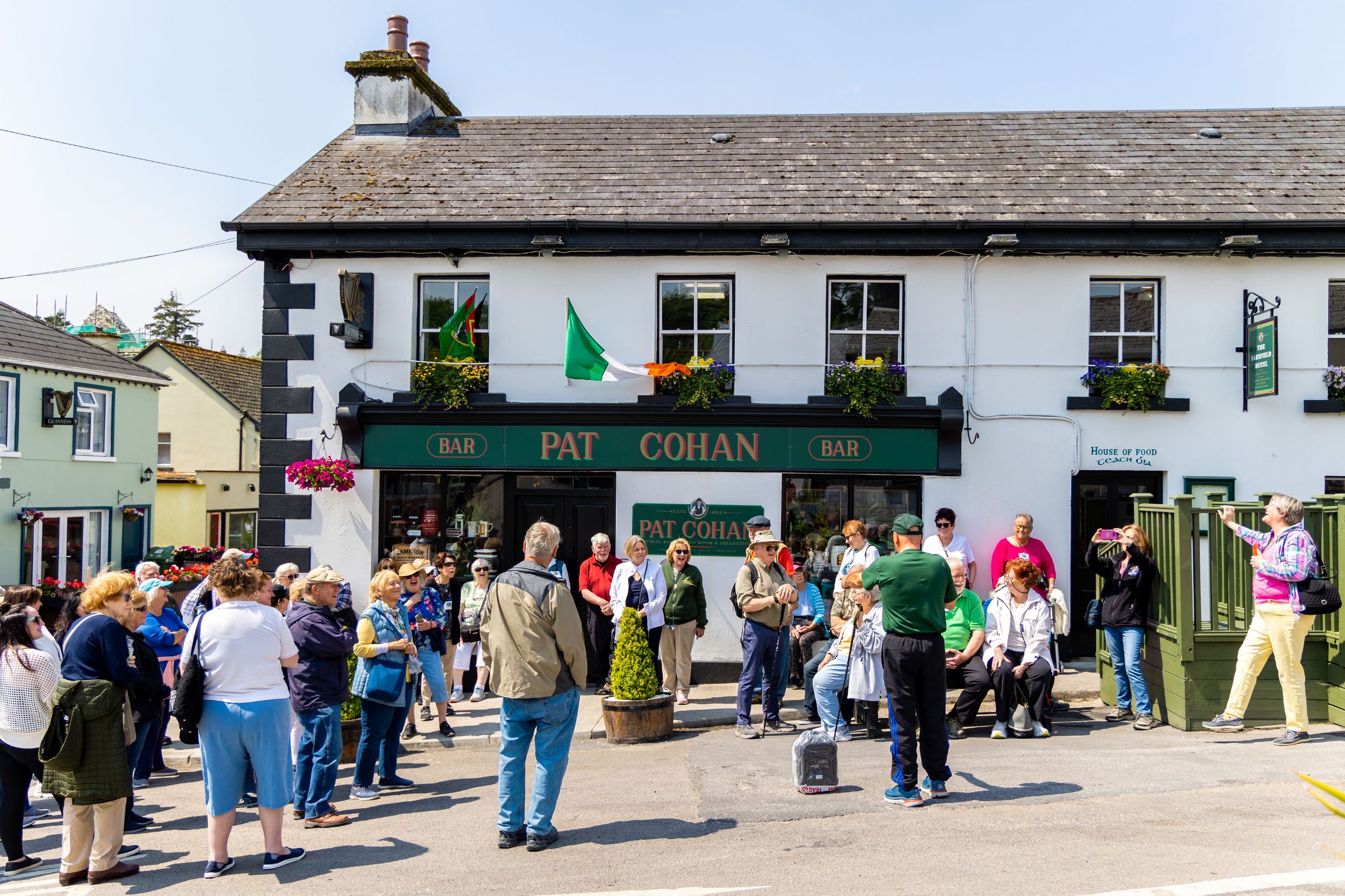 Group of tourists walking streets of Cong