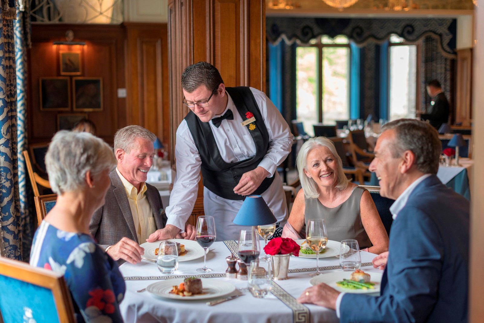 Guests enjoying a Celebration Dinner in the George V dining room in Ashford Castle, Ireland