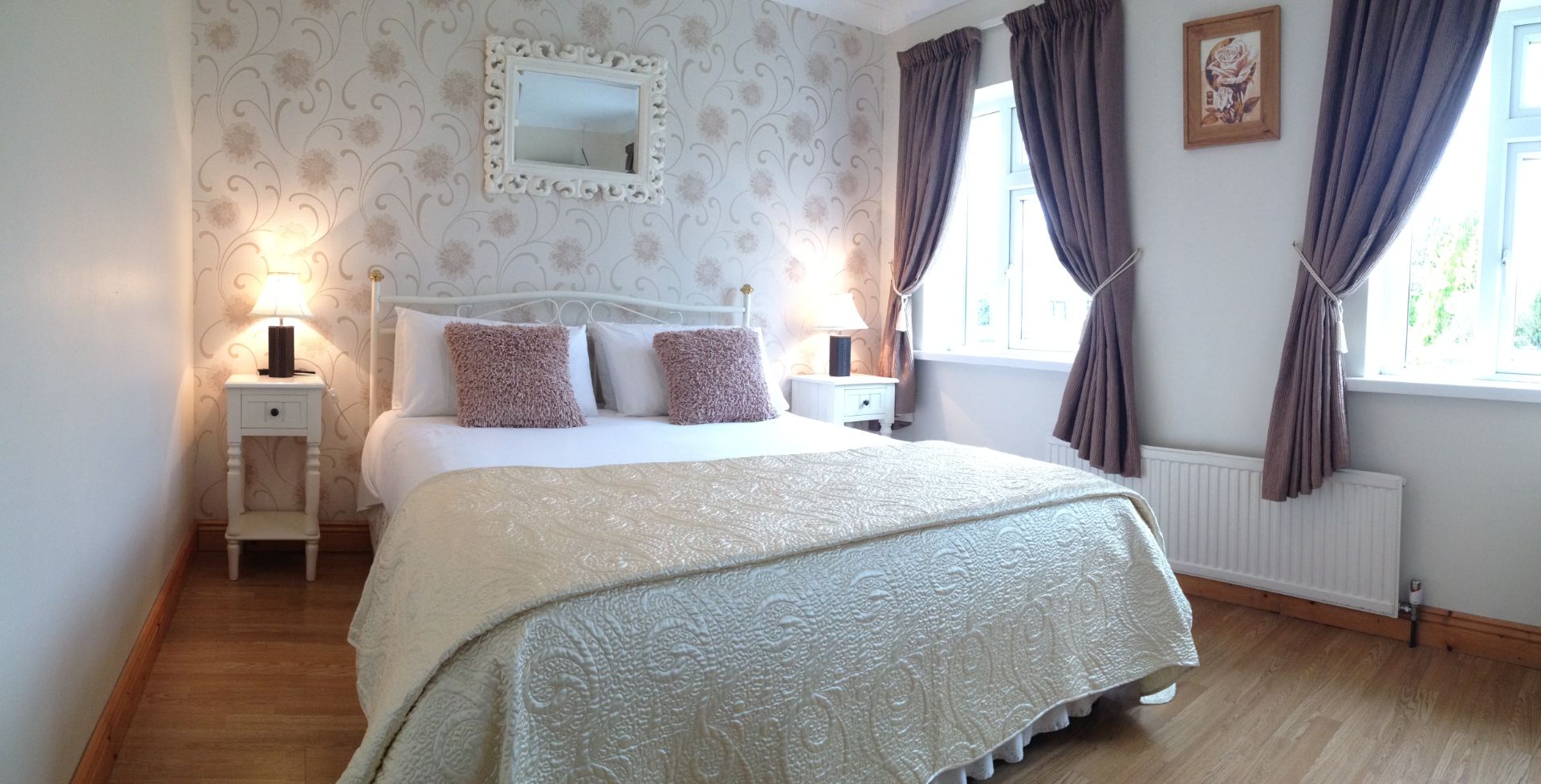 A bedroom with a bed and a mirror on the wall