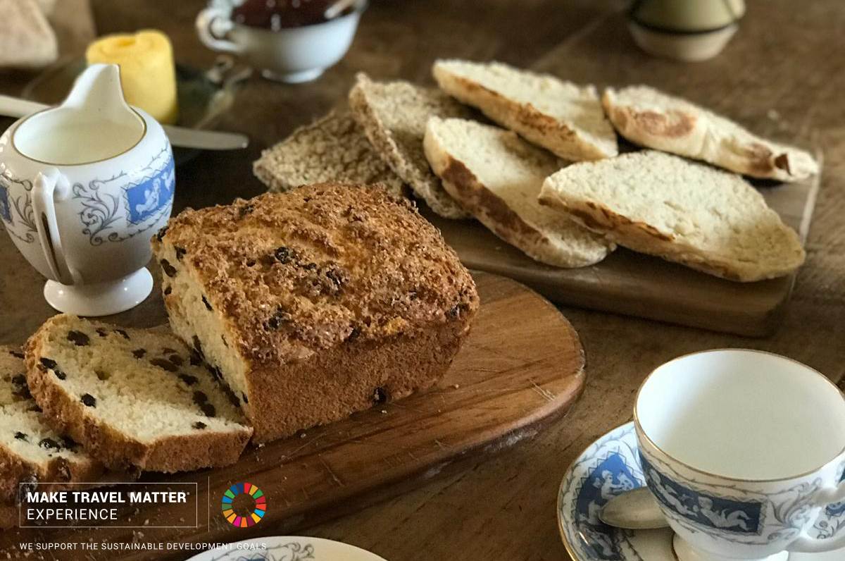 A wooden table topped with slices of bread and tea cups
