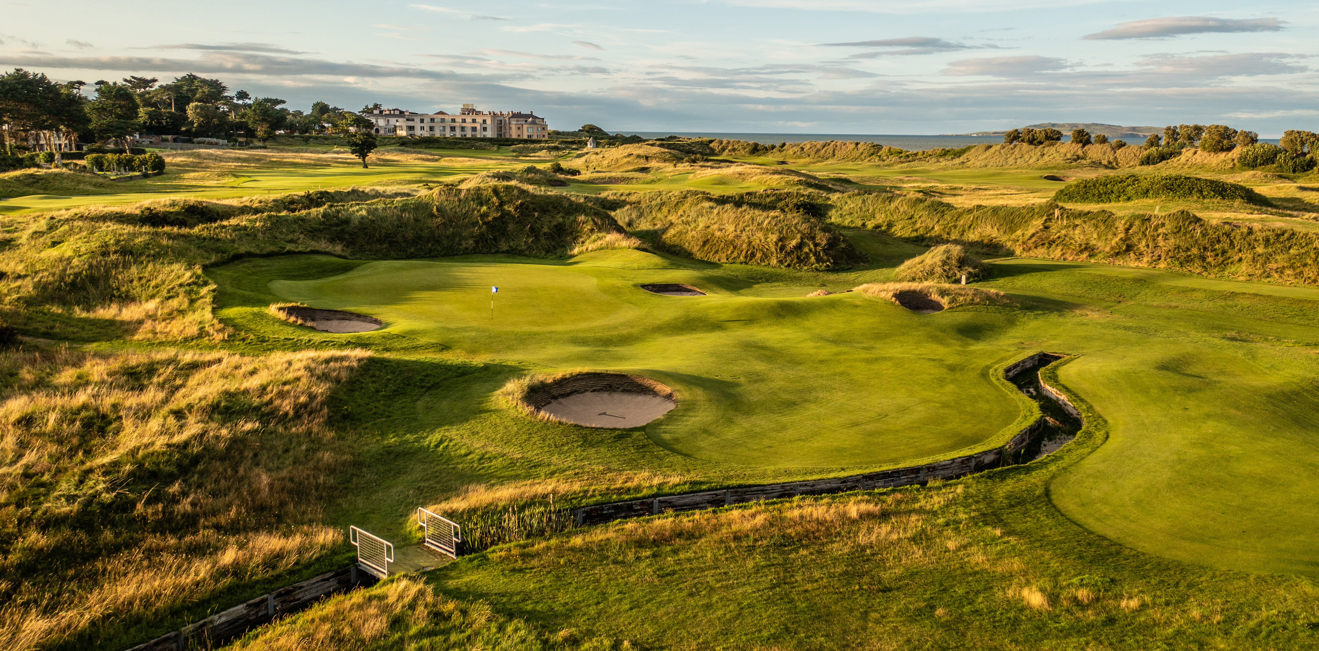 Rolling greens of Portmarnock golf course with hotel in the back ground
