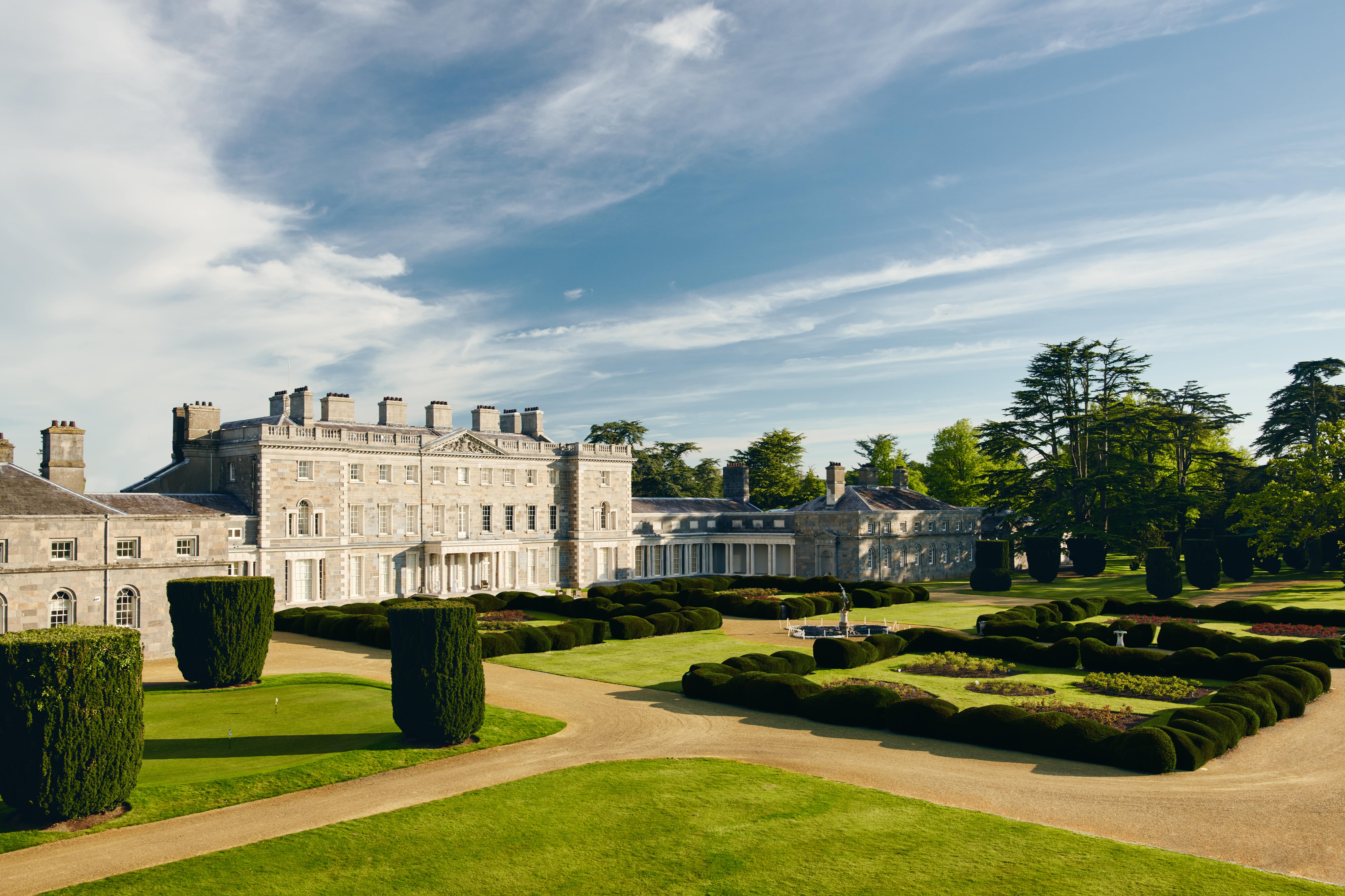 Carton House in Kildare with a garden in front of it 