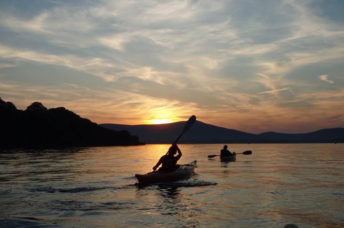 A couple of people in a kayak on a body of water