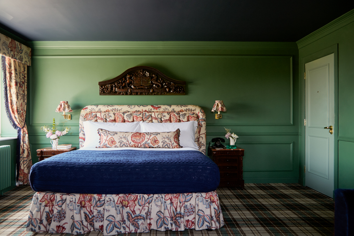 A bedroom with a large bed and green walls in Slieve Donard, Northern Ireland 