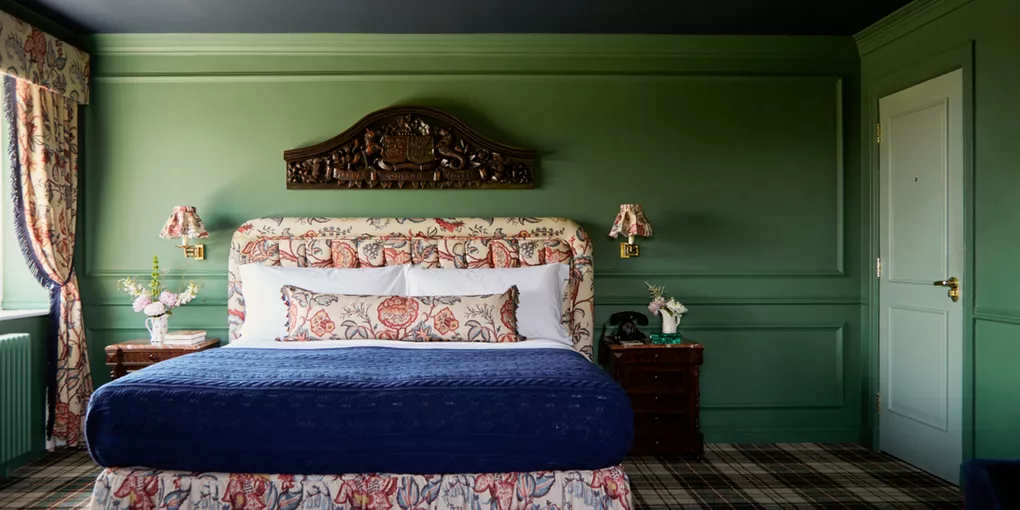 A bedroom with a large bed and green walls in Slieve Donard, Northern Ireland