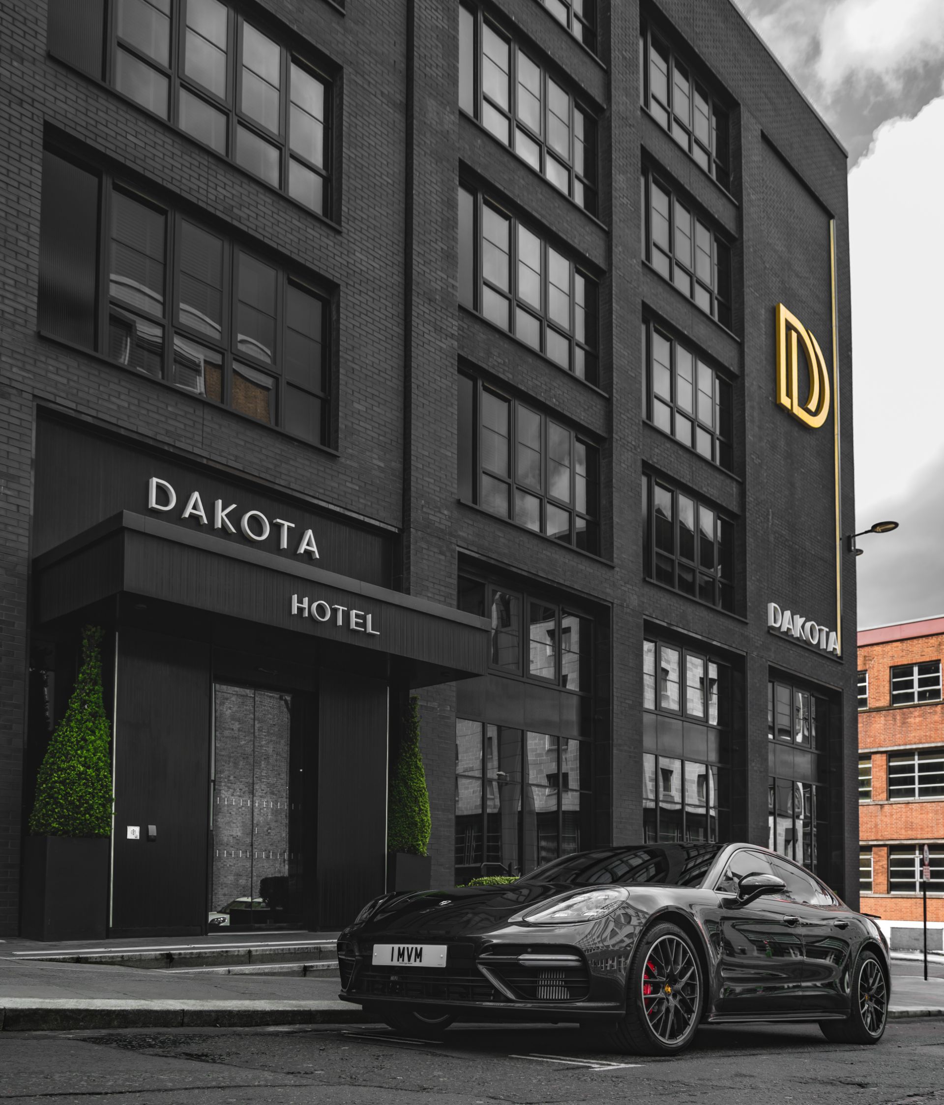 A black sports car parked in front of a hotel