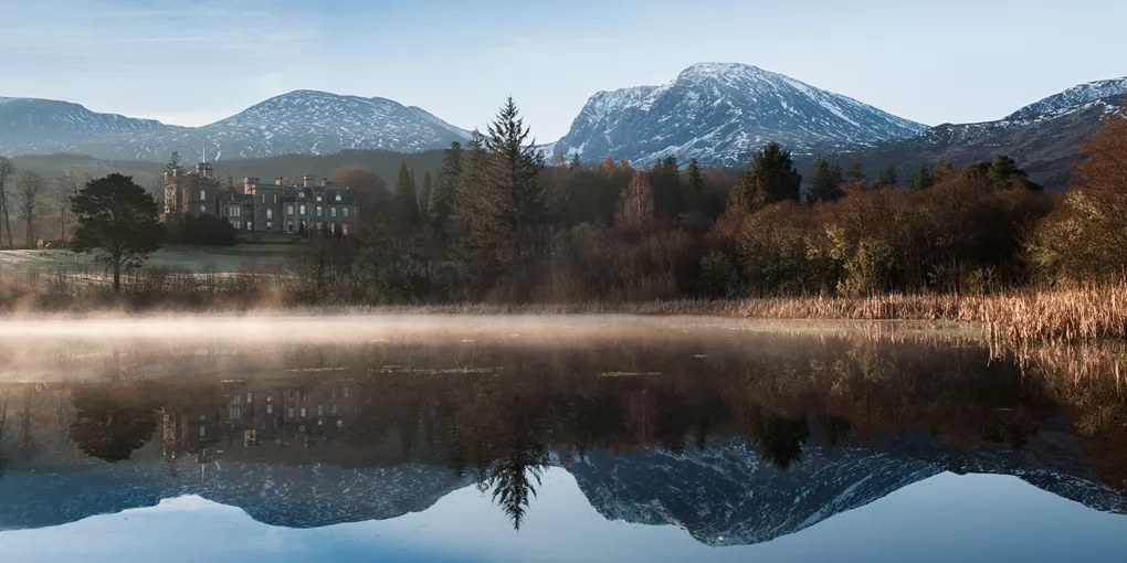 Inverlochy Castle in Scotland's Highlands surrounded by hills and lake
