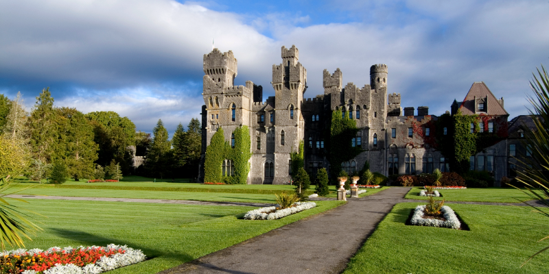 Castle with green lawns and pretty colourful flower beds
