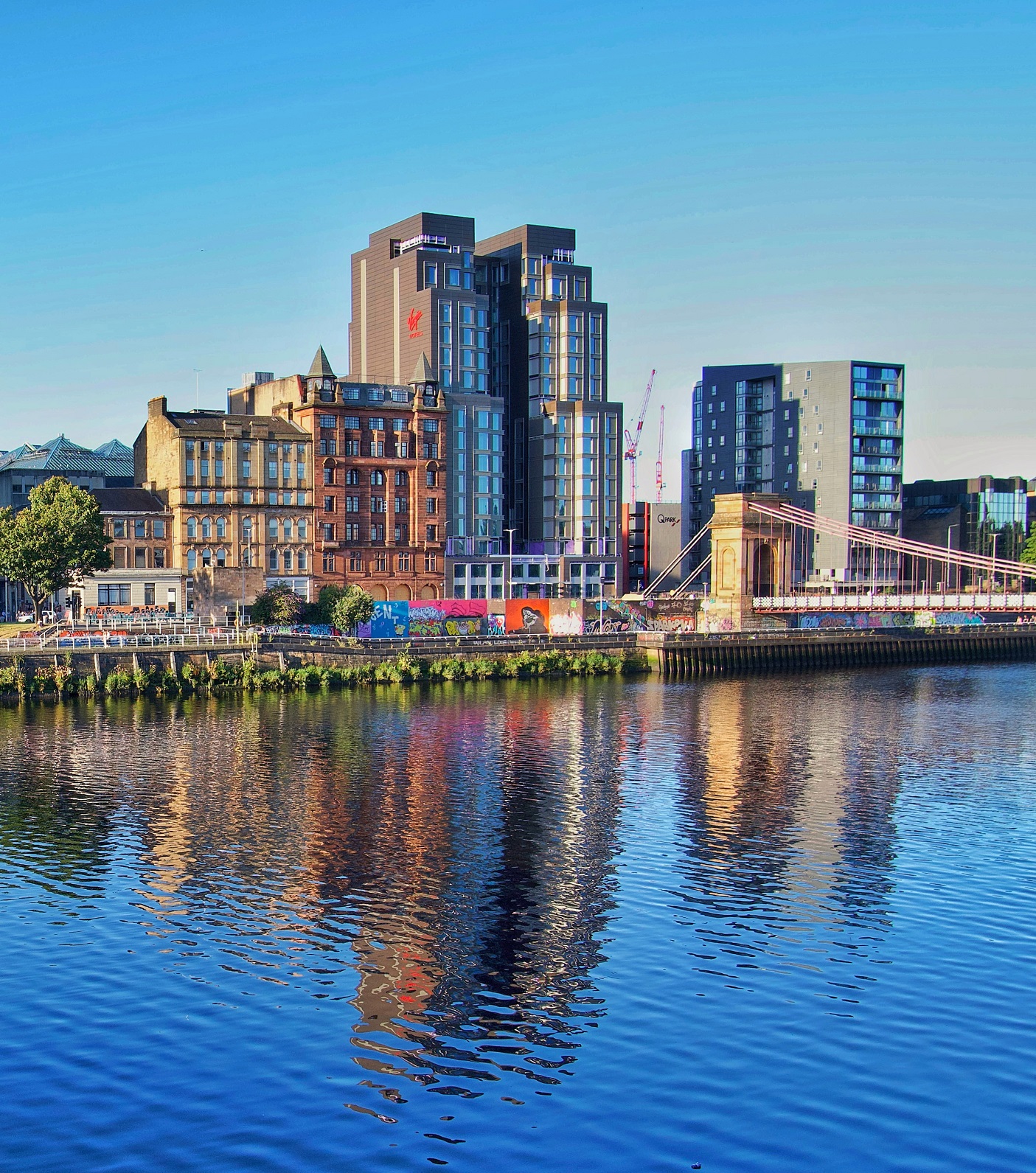 A body of water with a city in the background