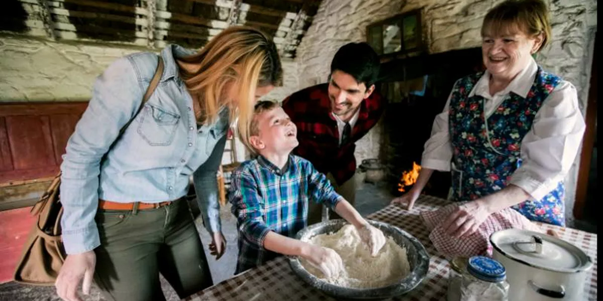 boy baking in a farm house with adults at muckross farm