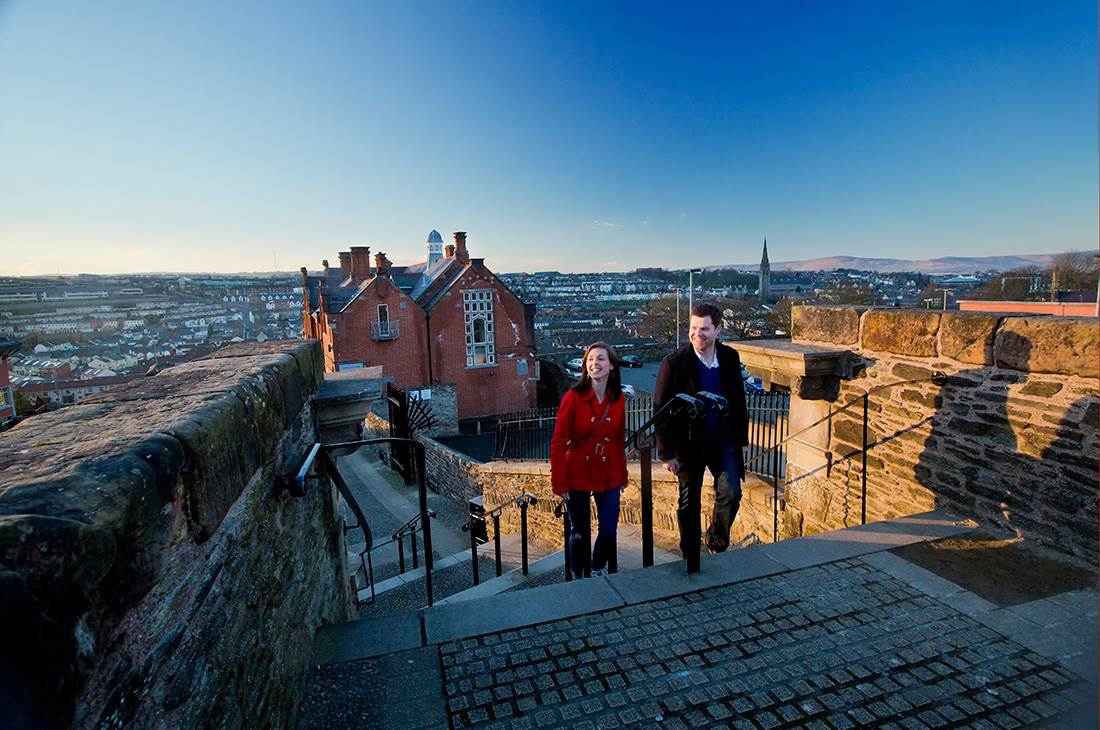 A couple walking on the Derry Walls