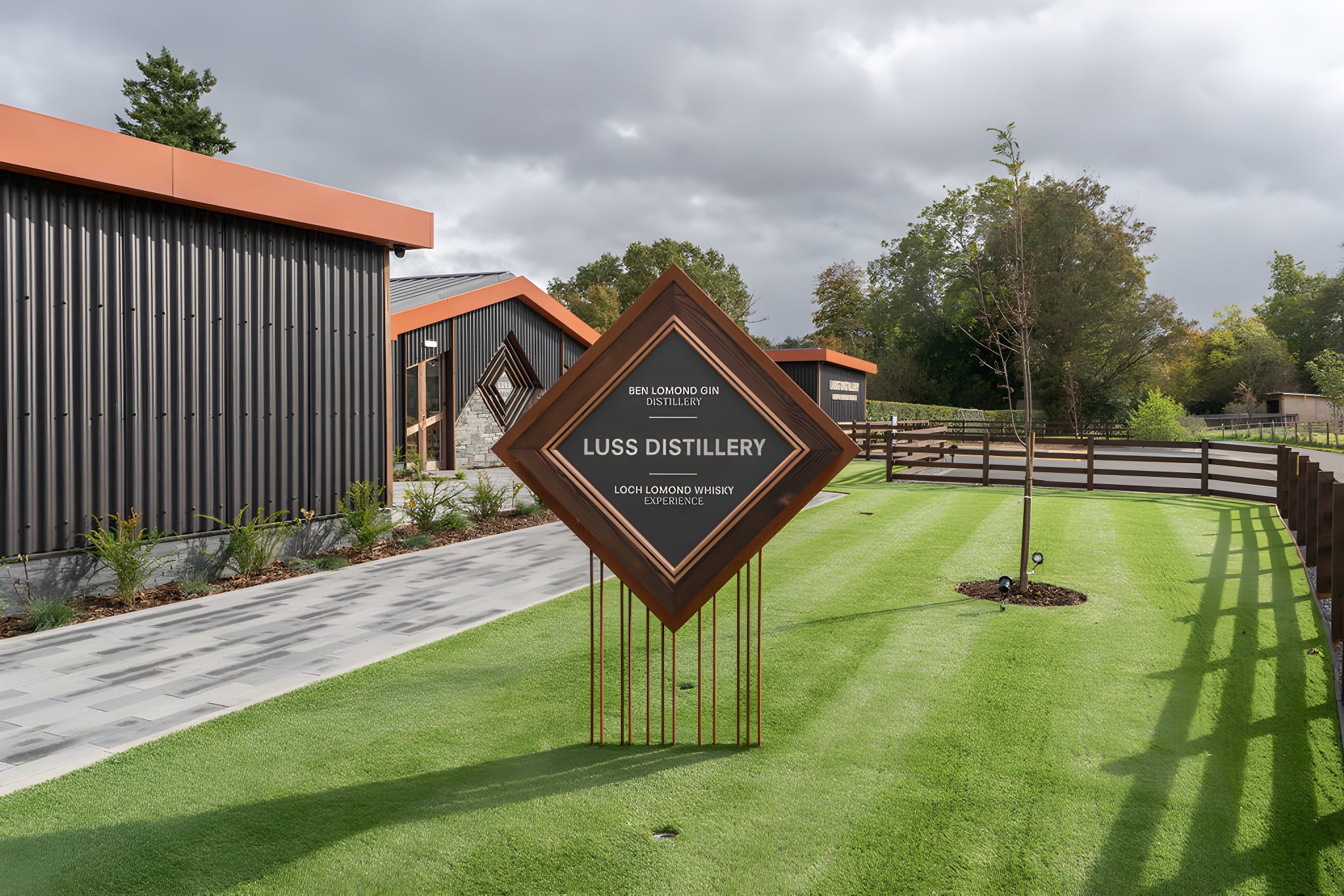 Luss Distillery and Loch Lomond Whisky Experience surrounded by landscaped grounds in Scotland.