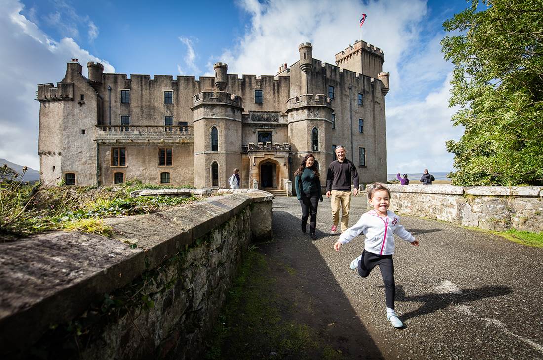 A couple with a running child walks away after a tour of the castle 