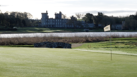 A golf course with a castle in the background