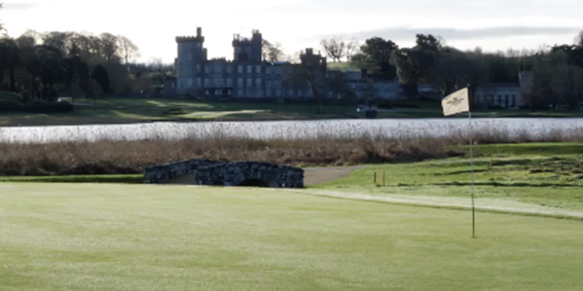 A golf course with a castle in the background