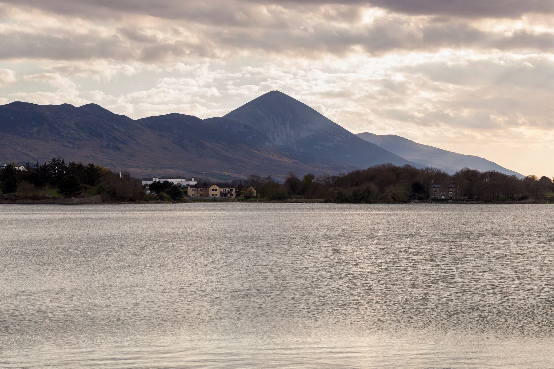 A large body of water with mountains in the background
