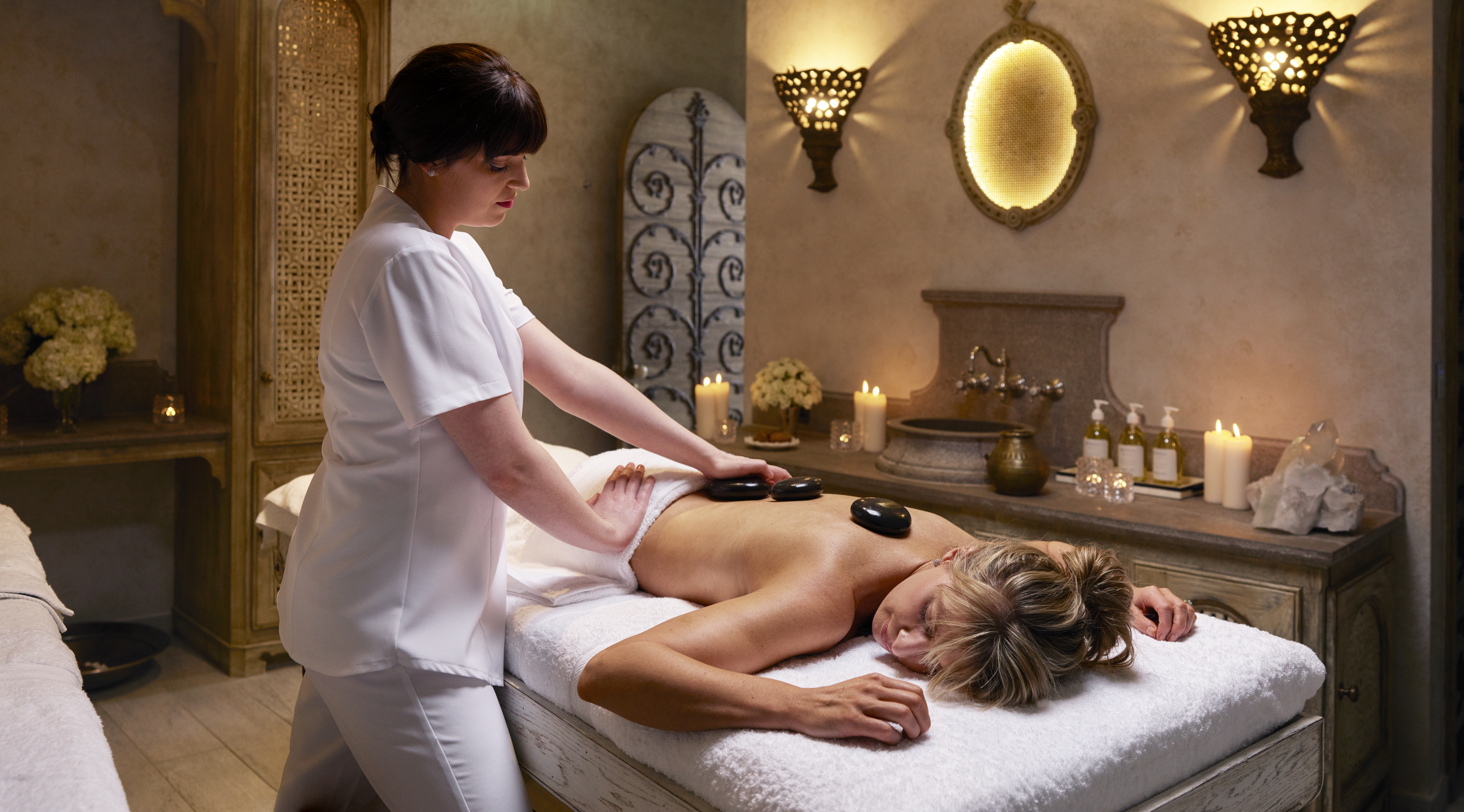 Woman enjoys a hot stone massage at Ashford Castle in Co. Mayo Ireland