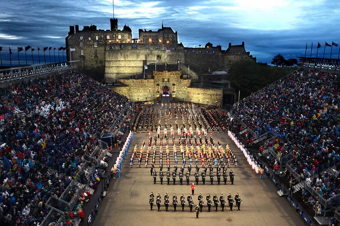Military parade and a large group of people standing in front of a castle