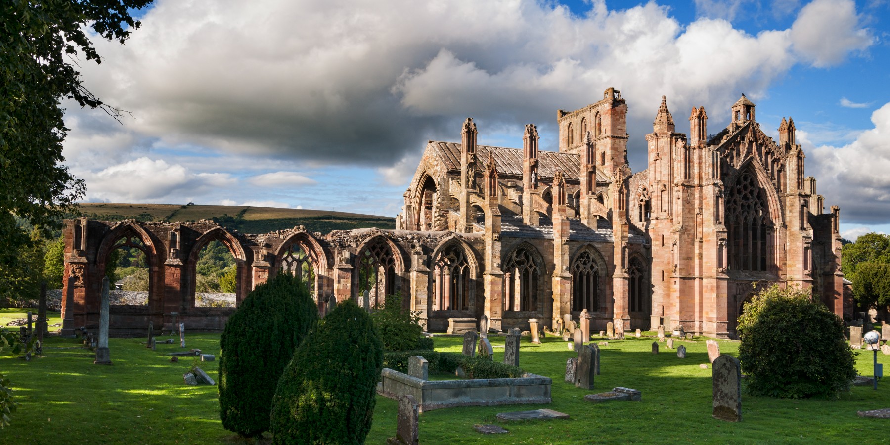 Large building with lawn and tombstones
