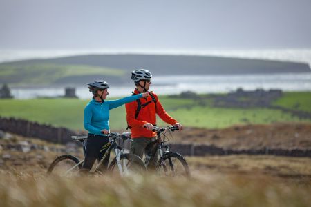 A couple of people on bikes in a field