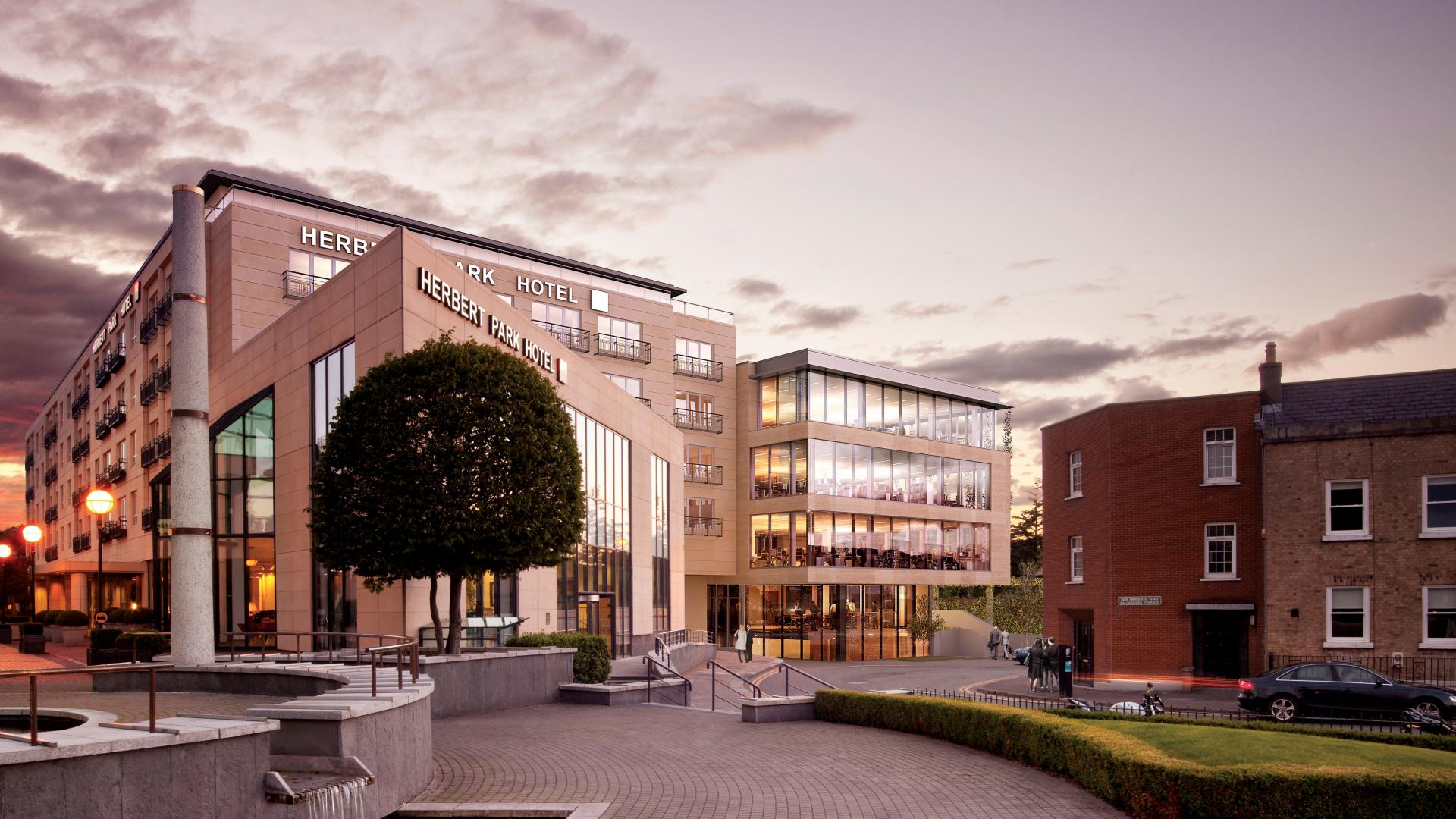 Exterior of the herbert park hotel at sunset