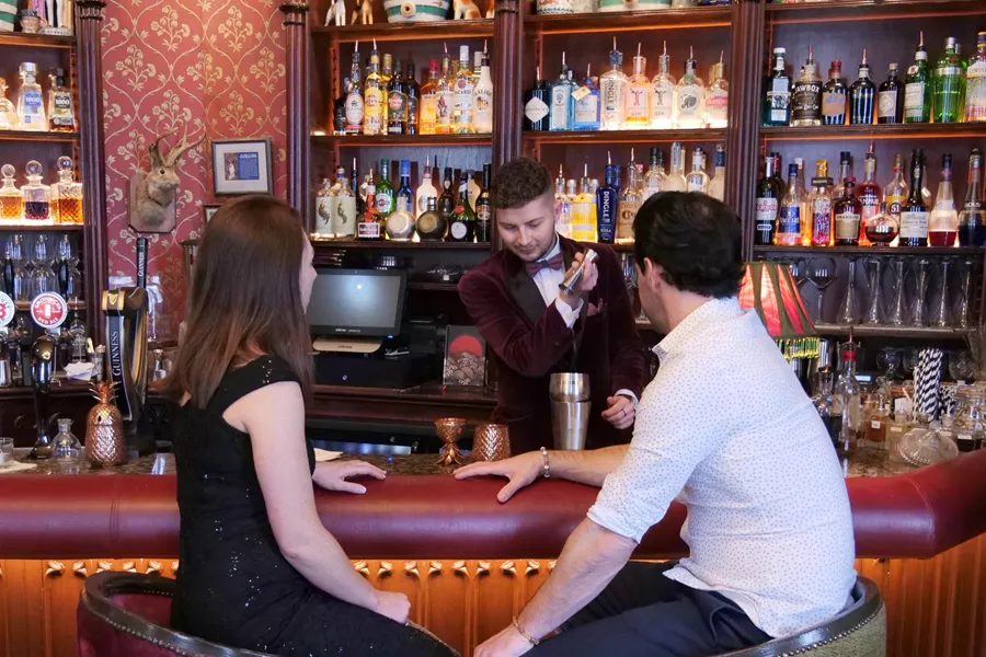 A man and a woman sitting at a bar