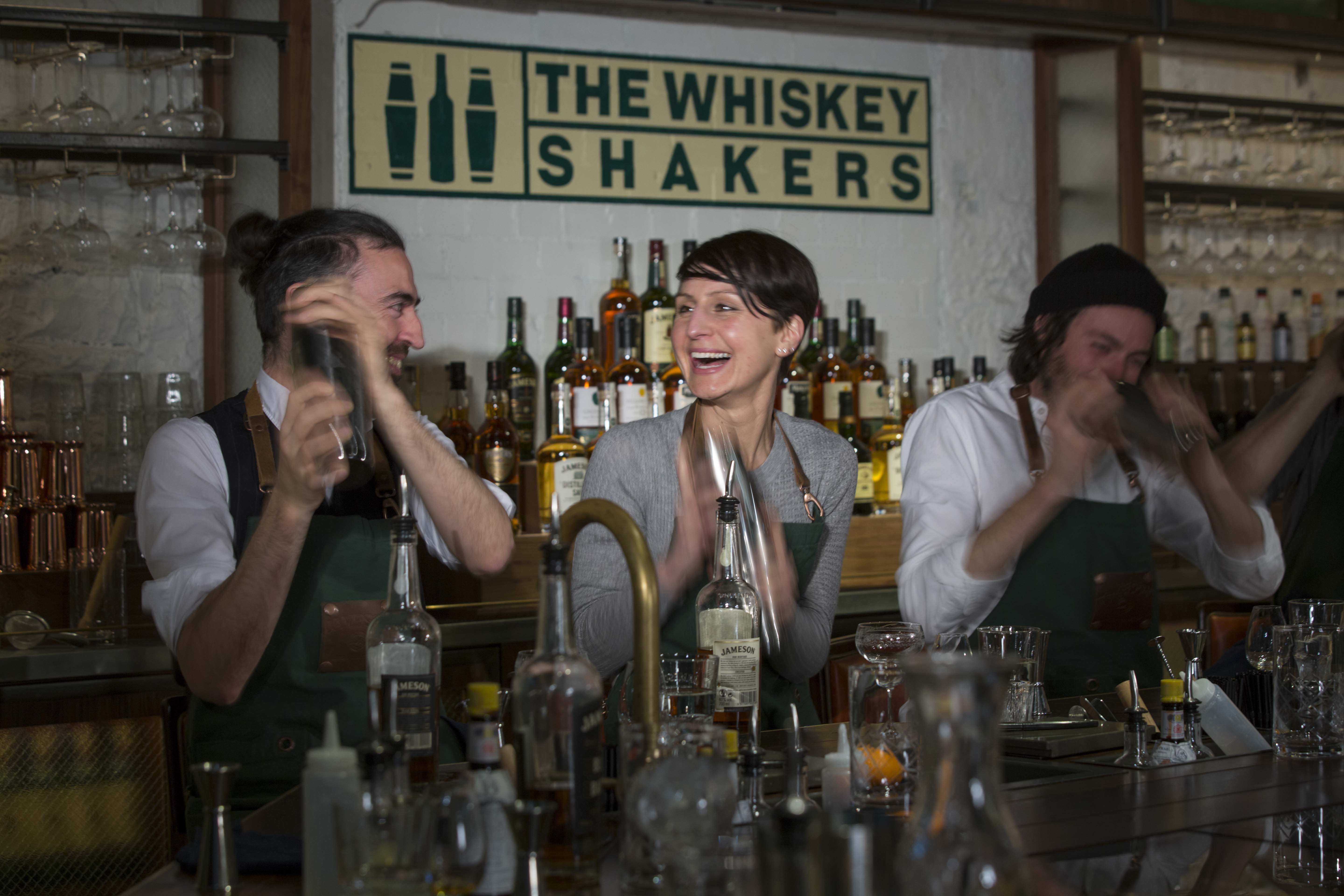Guests learn the secrets of whiskey shaking at the Jameson Distillery in Dublin Ireland