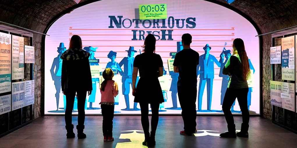 A group of people standing in front of a display in museum