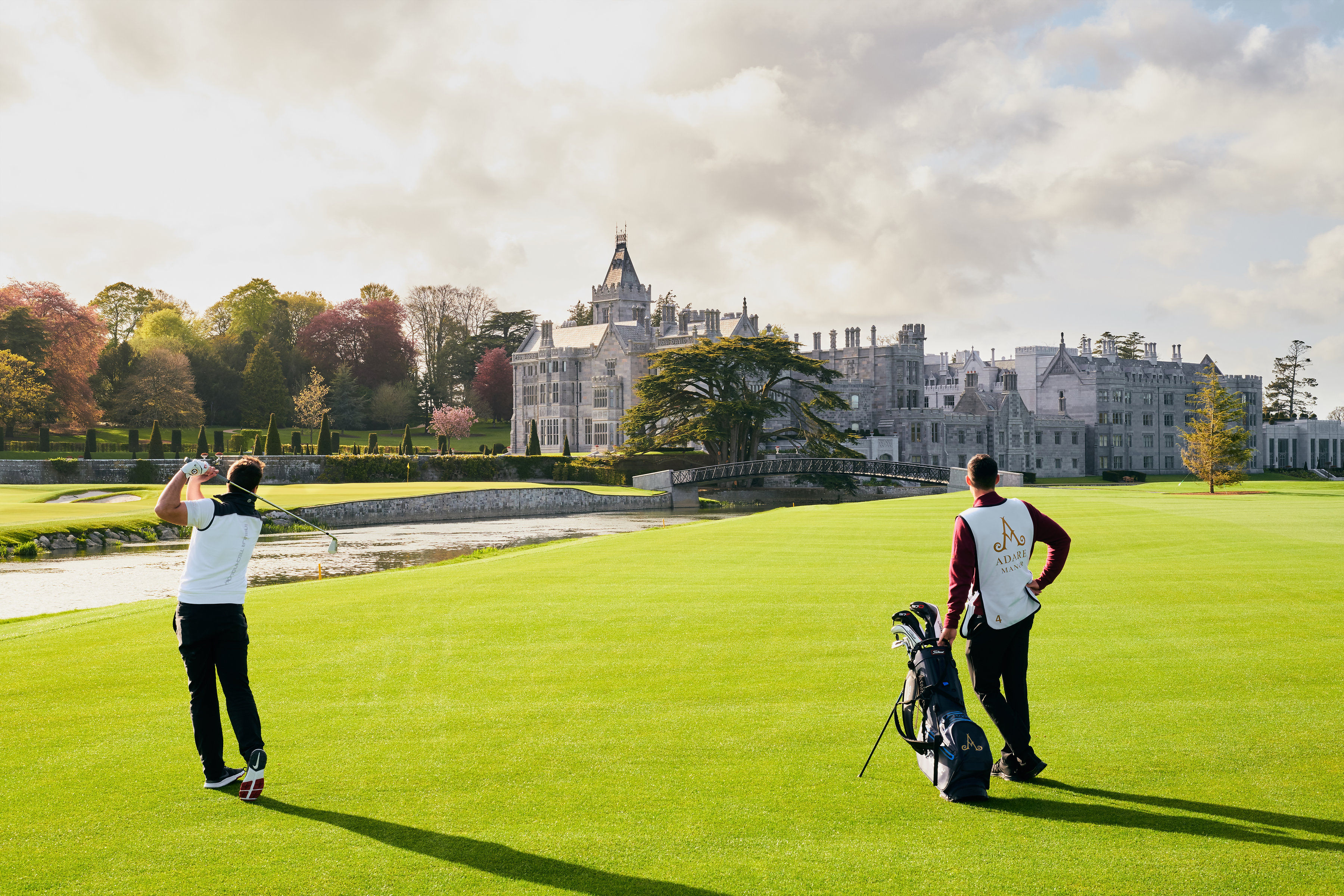 Golfers playing on the grounds of the Adare manor