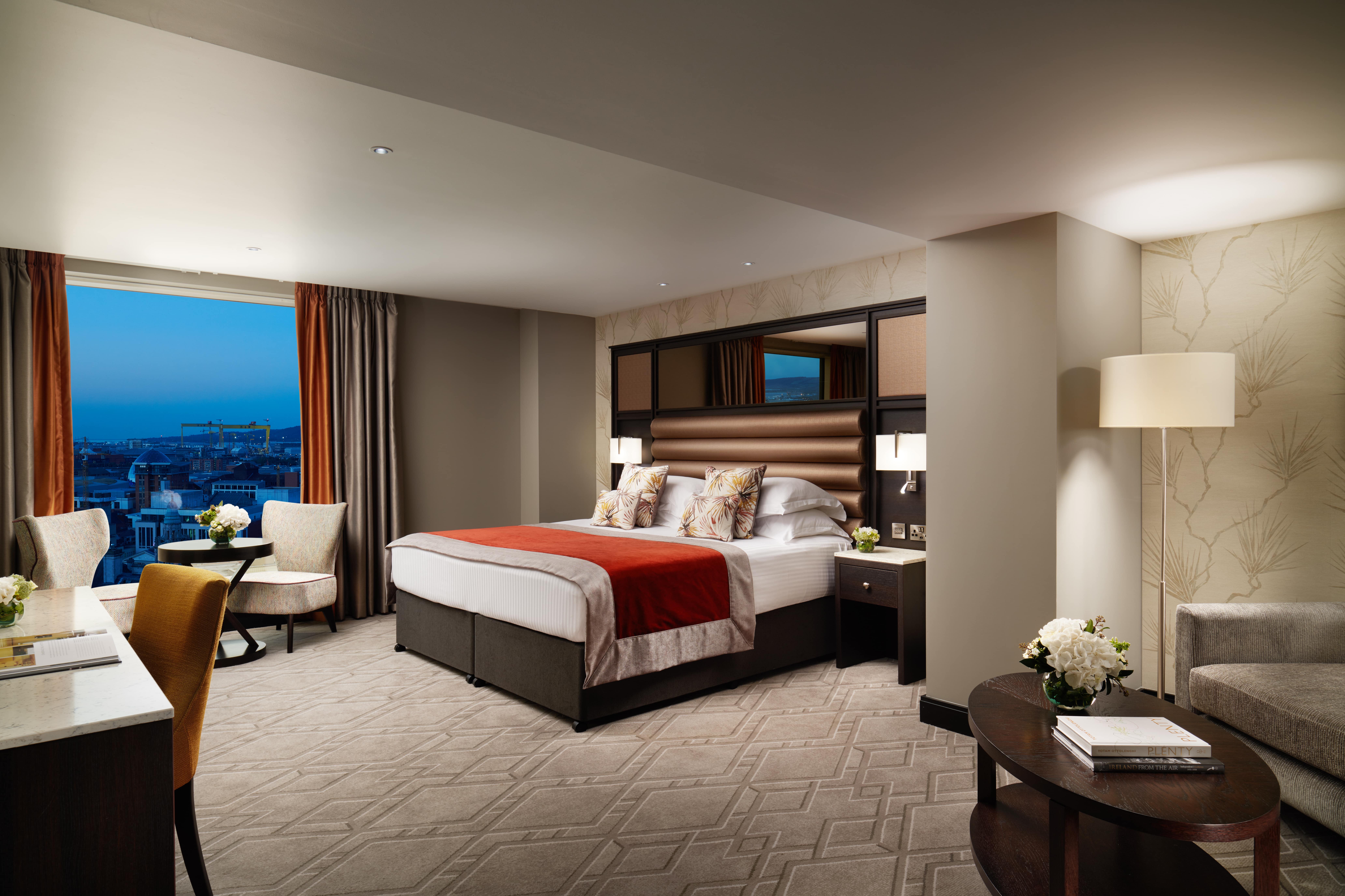 A bedroom with a large window in Grand Central Hotel in Northern Ireland