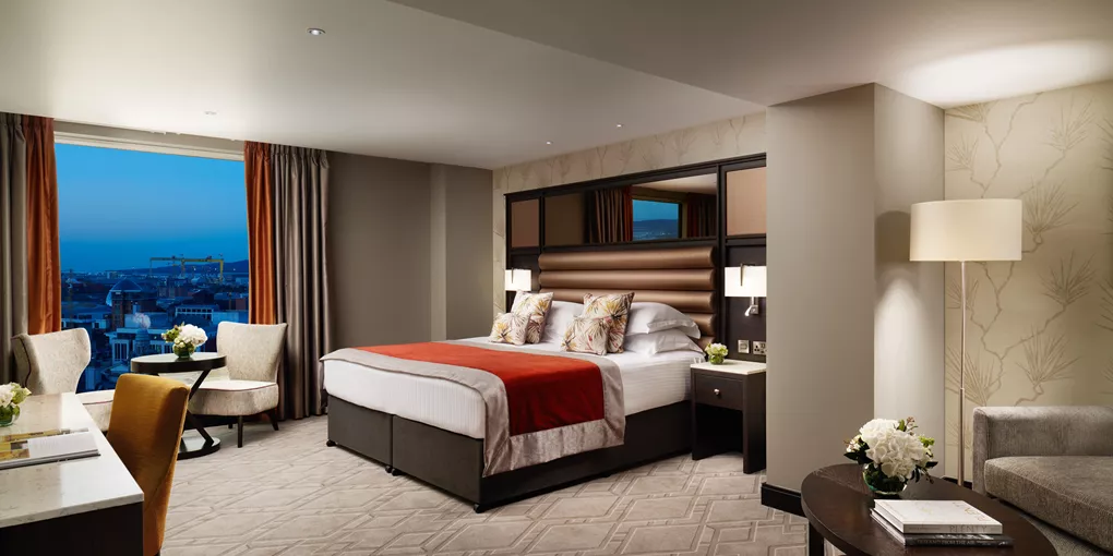 A bedroom with a large window in Grand Central Hotel in Northern Ireland