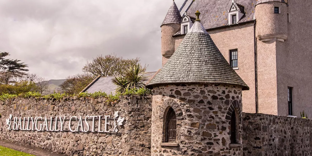 Ballygally Castle exterior with a stone fence around it