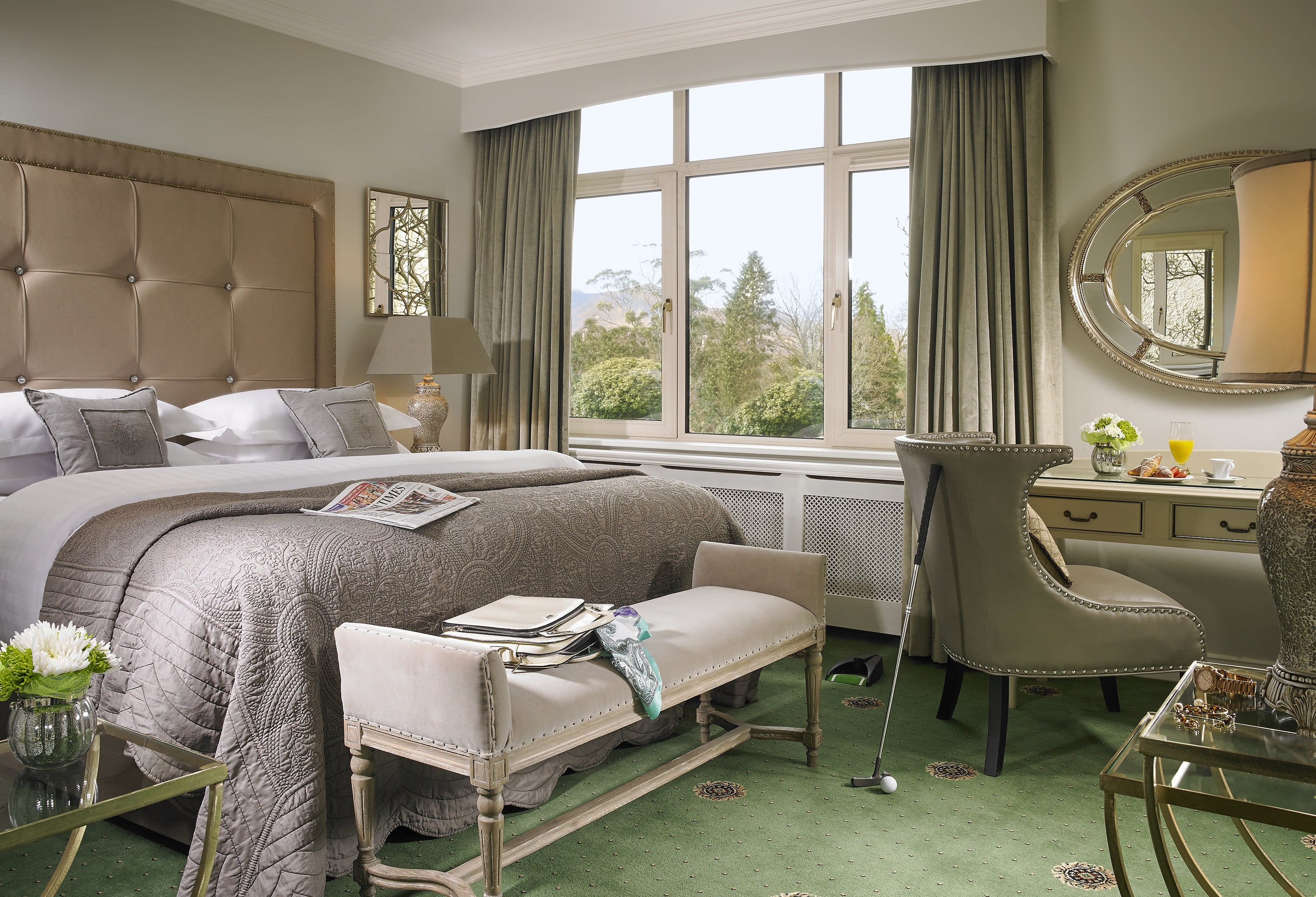 A bedroom with a large bed and a large window