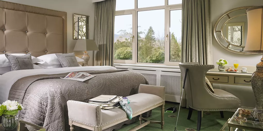 A bedroom with a large bed and a large window