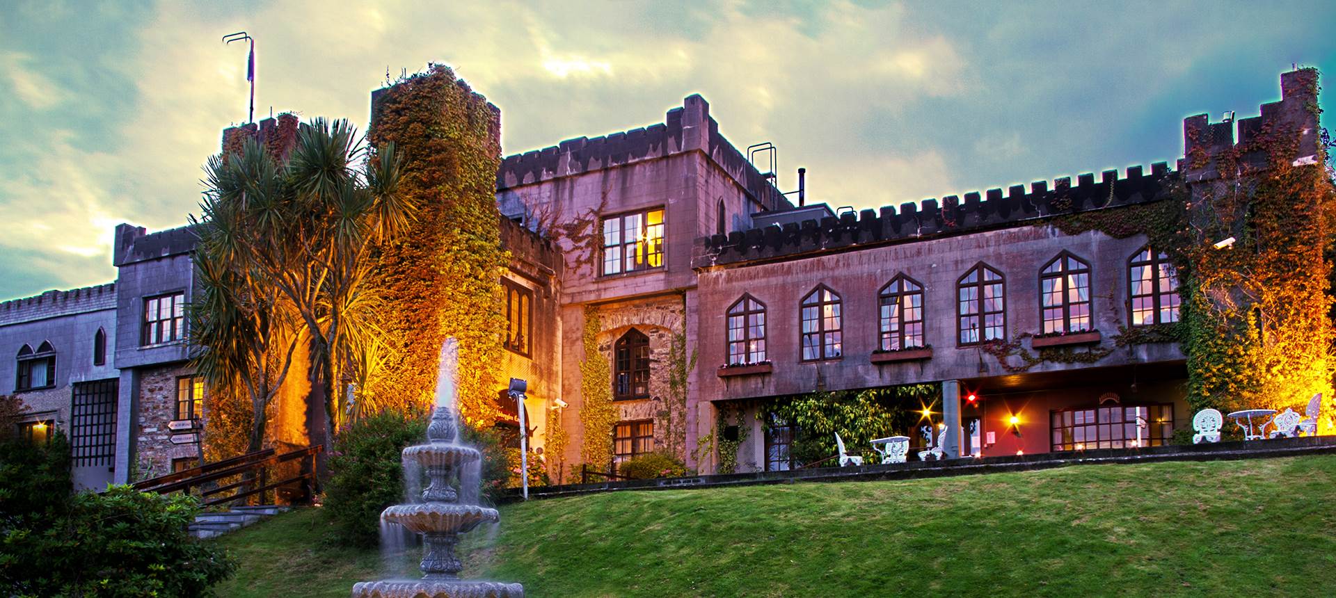 A large building with a fountain in front of it 